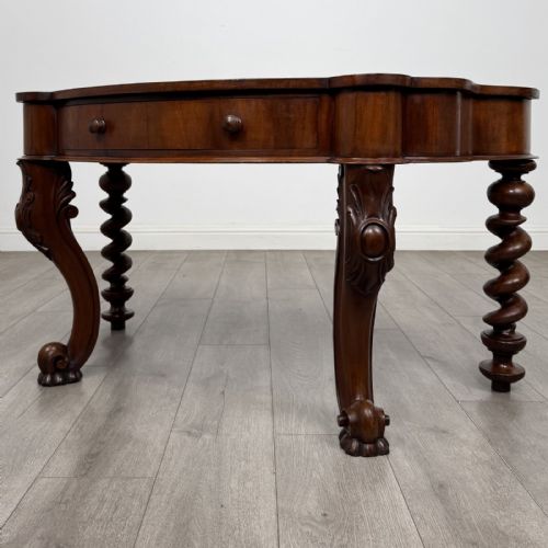fig 1. A Victorian mahogany console table with carved cabriole front legs, spiral rear legs, and a single drawer with round wooden handles.