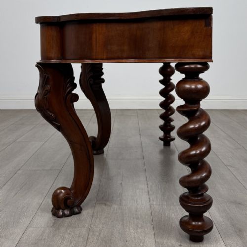 fig 2. A Victorian mahogany console table with carved cabriole front legs, spiral rear legs, and a single drawer with round wooden handles.