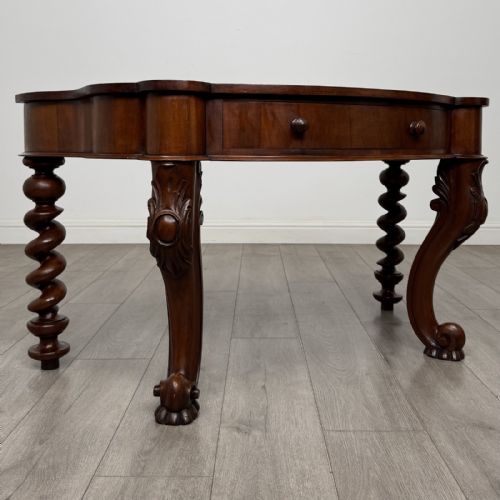 fig 7. A Victorian mahogany console table with carved cabriole front legs, spiral rear legs, and a single drawer with round wooden handles.