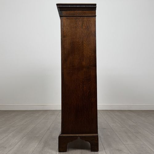 fig 3. A dark oak Georgian style display cabinet featuring twin glazed doors with rectangular timber mullions and bracket feet.