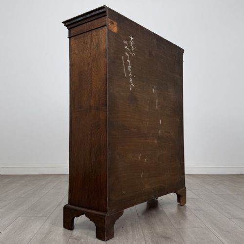 fig 4. A dark oak Georgian style display cabinet featuring twin glazed doors with rectangular timber mullions and bracket feet.