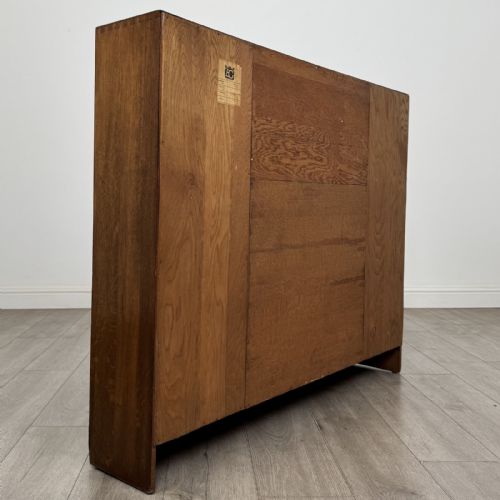 fig 5. An Art Deco oak side-by-side bureau bookcase with a central slant-front desk above panelled cupboards, flanked by two glazed display cabinets.