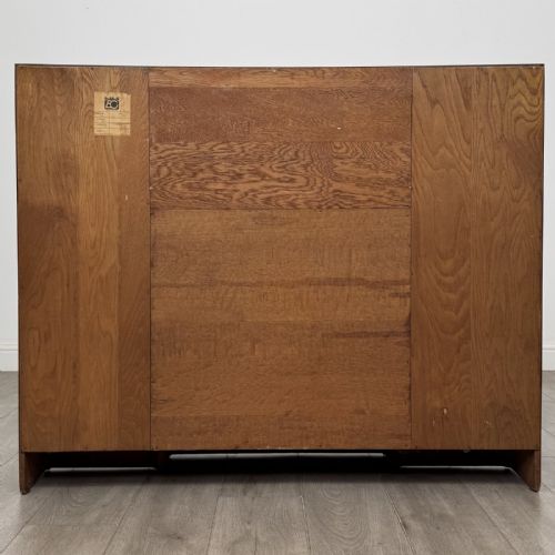 fig 6. An Art Deco oak side-by-side bureau bookcase with a central slant-front desk above panelled cupboards, flanked by two glazed display cabinets.