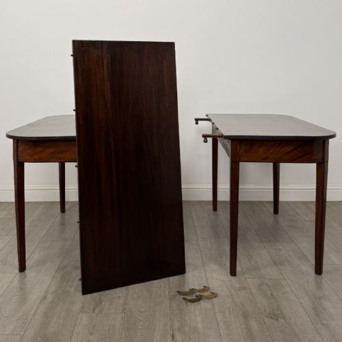 fig 7. An antique Georgian dark mahogany extending dining table featuring rounded D-end corners, a removable leaf, and square tapered legs.