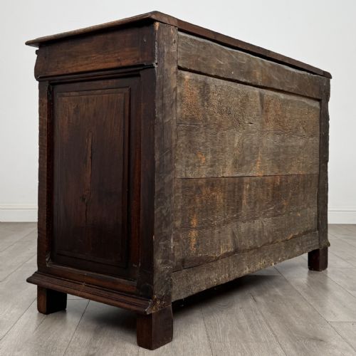 fig 3. A 19th-century French dark walnut sideboard featuring twin panelled doors with drop handles, flanked by fluted pilasters, with a carved winged cherub head centred on the frieze.