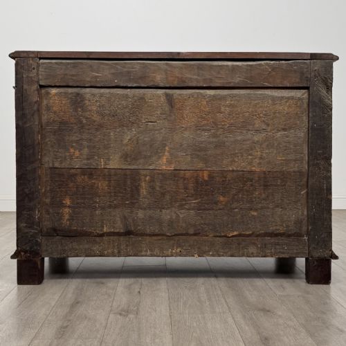 fig 4. A 19th-century French dark walnut sideboard featuring twin panelled doors with drop handles, flanked by fluted pilasters, with a carved winged cherub head centred on the frieze.