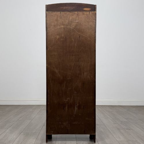fig 4. A tall, narrow dark oak open bookcase featuring five bow-fronted shelves and a curved gallery top.