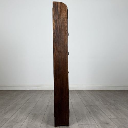 fig 6. A tall, narrow dark oak open bookcase featuring five bow-fronted shelves and a curved gallery top.