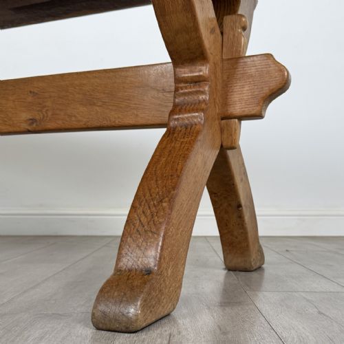 fig 5. A large 20th-century oak dining table featuring a rectangular wooden top supported by two trestle-style X-frame legs joined by a central horizontal stretcher.