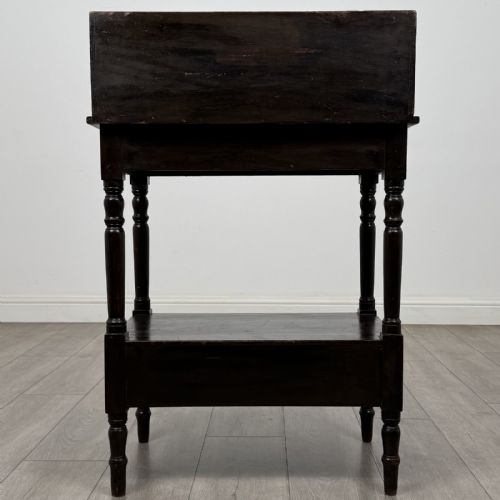 fig 4. A dark stained Victorian pine washstand featuring a three-quarter gallery back, turned legs, a lower shelf, and a base drawer with two turned wooden knobs.