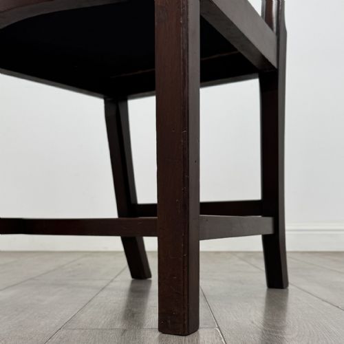 fig 5. A set of four dark mahogany dining chairs featuring carved pierced splats, straight square legs with H-stretchers, and patterned upholstered seats.