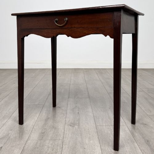 fig 1. An 18th-century Georgian mahogany side table with a single frieze drawer, brass handle, shaped apron, and straight square legs.