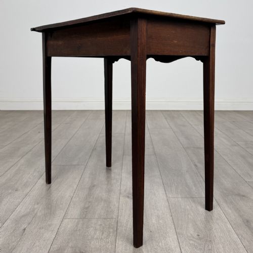 fig 5. An 18th-century Georgian mahogany side table with a single frieze drawer, brass handle, shaped apron, and straight square legs.
