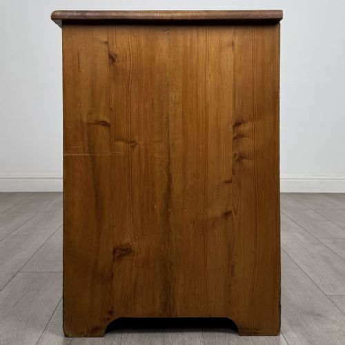 fig 2. A Victorian stripped pine cupboard featuring two top drawers with brass knobs above two panelled doors.