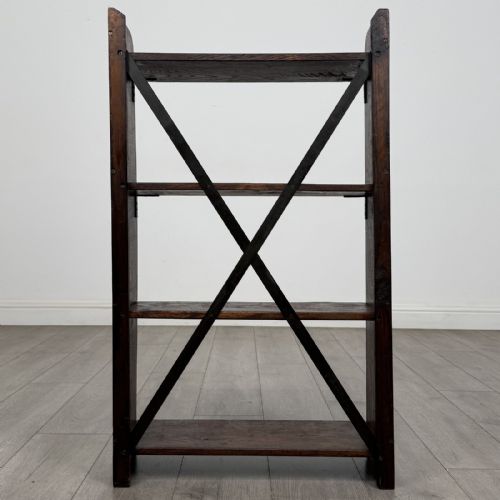 fig 3. An open dark oak bookcase featuring three shelves and a black iron cross back stretcher.