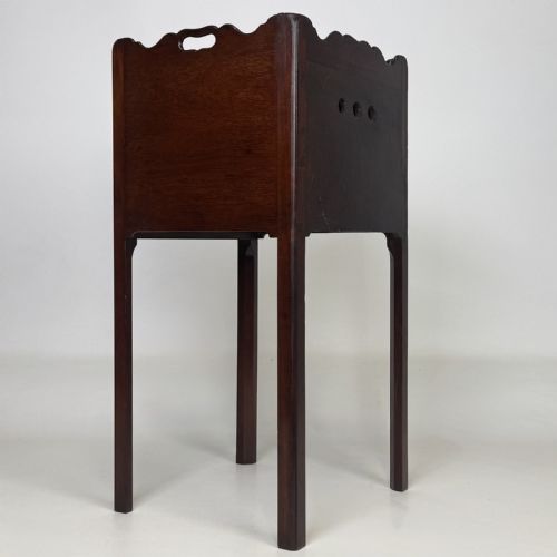 fig 3. A tall dark mahogany bedside cabinet featuring a gallery tray top, single cupboard door, and square legs.