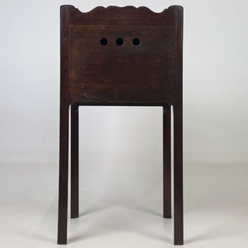 fig 4. A tall dark mahogany bedside cabinet featuring a gallery tray top, single cupboard door, and square legs.