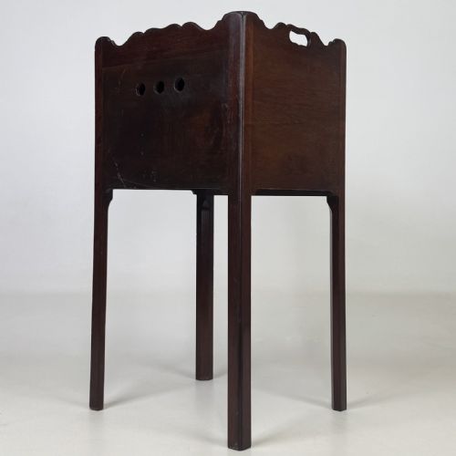 fig 5. A tall dark mahogany bedside cabinet featuring a gallery tray top, single cupboard door, and square legs.