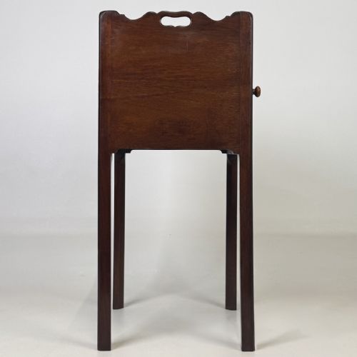 fig 6. A tall dark mahogany bedside cabinet featuring a gallery tray top, single cupboard door, and square legs.