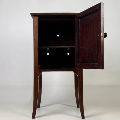 fig 1. An Edwardian mahogany bedside cabinet with an inlaid oval door panel and slim square tapered legs.