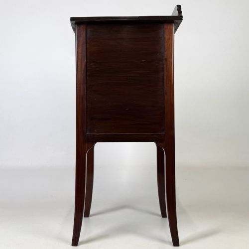 fig 3. An Edwardian mahogany bedside cabinet with an inlaid oval door panel and slim square tapered legs.