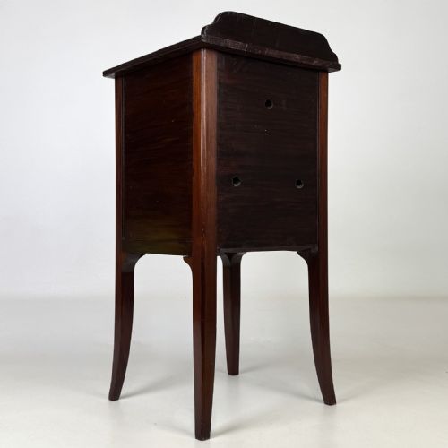 fig 4. An Edwardian mahogany bedside cabinet with an inlaid oval door panel and slim square tapered legs.
