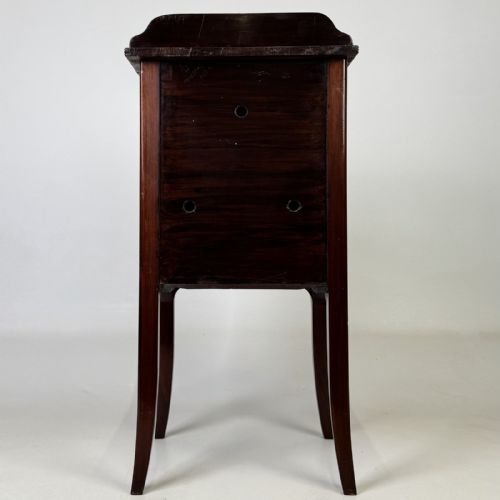 fig 5. An Edwardian mahogany bedside cabinet with an inlaid oval door panel and slim square tapered legs.