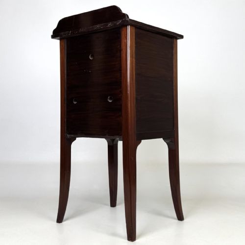 fig 6. An Edwardian mahogany bedside cabinet with an inlaid oval door panel and slim square tapered legs.