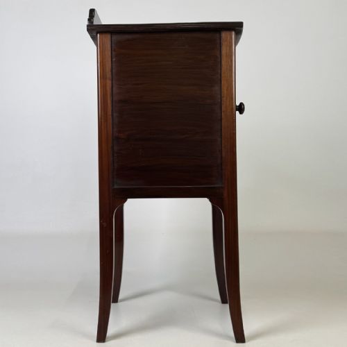 fig 7. An Edwardian mahogany bedside cabinet with an inlaid oval door panel and slim square tapered legs.