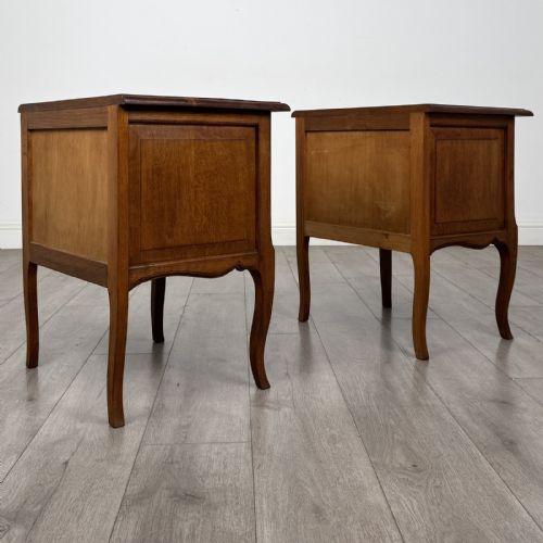 fig 6. A matching pair of vintage warm oak French style bedside cabinets featuring cabriole legs, single panelled doors, and metal knobs.