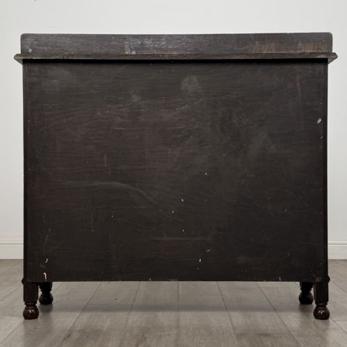 fig 4. A dark oak Jacobean style display cabinet featuring twin leaded glass doors, central carved bosses, internal shelving, and turned feet.