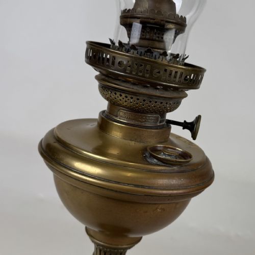 fig 3. An antique brass column oil lamp featuring an etched glass globe shade, clear chimney, brass reservoir, fluted stem, and dark veined marble base.