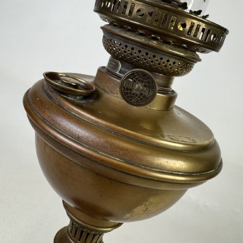 fig 4. An antique brass column oil lamp featuring an etched glass globe shade, clear chimney, brass reservoir, fluted stem, and dark veined marble base.