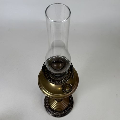fig 6. An antique brass column oil lamp featuring an etched glass globe shade, clear chimney, brass reservoir, fluted stem, and dark veined marble base.