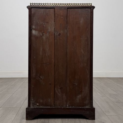 fig 4. A Victorian burr walnut music cabinet featuring a single glazed door revealing internal shelves with gilt-embossed text labels.