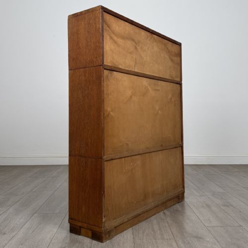 fig 4. A 20th-century oak stacking bookcase featuring a double-door wooden top cabinet above two tiered sliding glass door compartments.