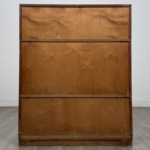 fig 5. A 20th-century oak stacking bookcase featuring a double-door wooden top cabinet above two tiered sliding glass door compartments.