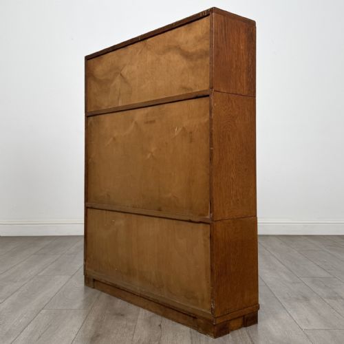 fig 6. A 20th-century oak stacking bookcase featuring a double-door wooden top cabinet above two tiered sliding glass door compartments.