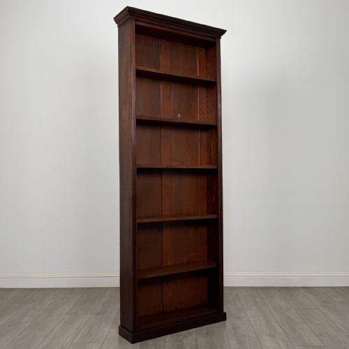 fig 8. A tall, narrow mahogany open bookcase featuring six shelving compartments, a moulded top cornice, and a solid plinth base.