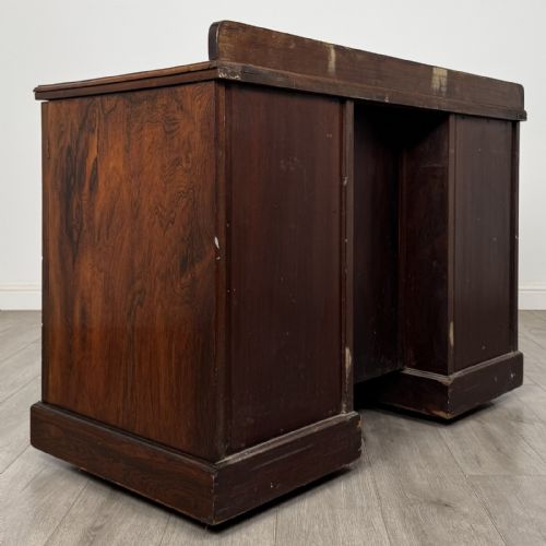 fig 3. A dark rosewood Victorian breakfront sideboard with three cupboard doors featuring intricate satinwood urn and scroll marquetry inlays.