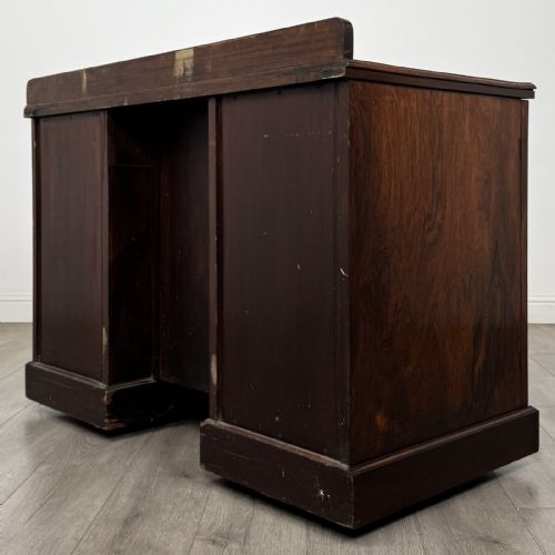 fig 5. A dark rosewood Victorian breakfront sideboard with three cupboard doors featuring intricate satinwood urn and scroll marquetry inlays.