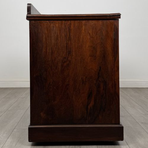 fig 6. A dark rosewood Victorian breakfront sideboard with three cupboard doors featuring intricate satinwood urn and scroll marquetry inlays.