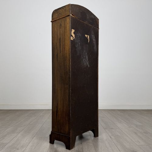 fig 4. A tall, narrow dark oak open bookcase featuring four fixed shelves, beaded front stiles, and a low arched top gallery rail.