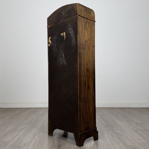 fig 6. A tall, narrow dark oak open bookcase featuring four fixed shelves, beaded front stiles, and a low arched top gallery rail.