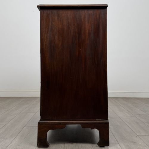 fig 2. An 18th-century Georgian mahogany chest of drawers featuring a two-over-three drawer configuration with brass swan-neck handles and bracket feet.