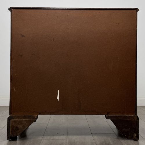 fig 4. An 18th-century Georgian mahogany chest of drawers featuring a two-over-three drawer configuration with brass swan-neck handles and bracket feet.