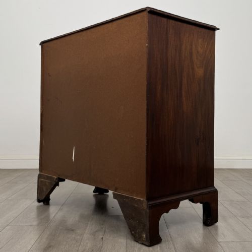 fig 5. An 18th-century Georgian mahogany chest of drawers featuring a two-over-three drawer configuration with brass swan-neck handles and bracket feet.