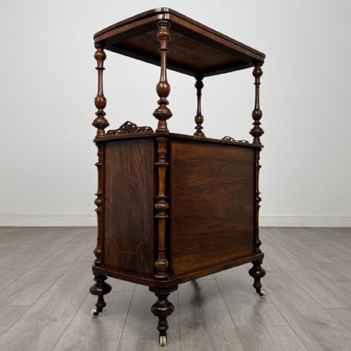 fig 3. A Victorian burr walnut cabinet featuring an upper tier with turned columns above a single glazed cupboard door with marquetry inlay.