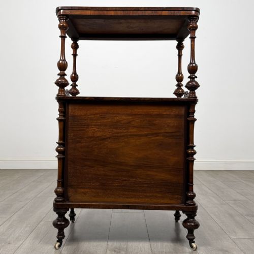 fig 4. A Victorian burr walnut cabinet featuring an upper tier with turned columns above a single glazed cupboard door with marquetry inlay.