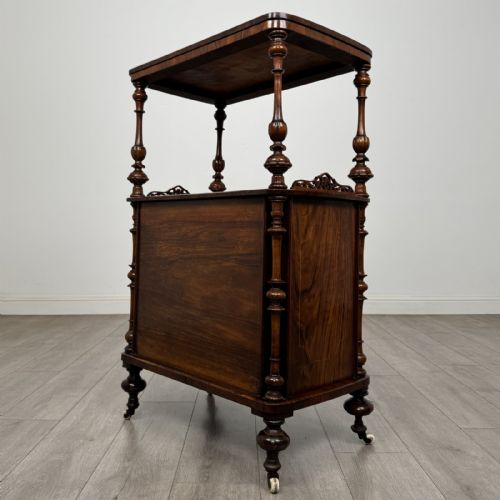 fig 5. A Victorian burr walnut cabinet featuring an upper tier with turned columns above a single glazed cupboard door with marquetry inlay.